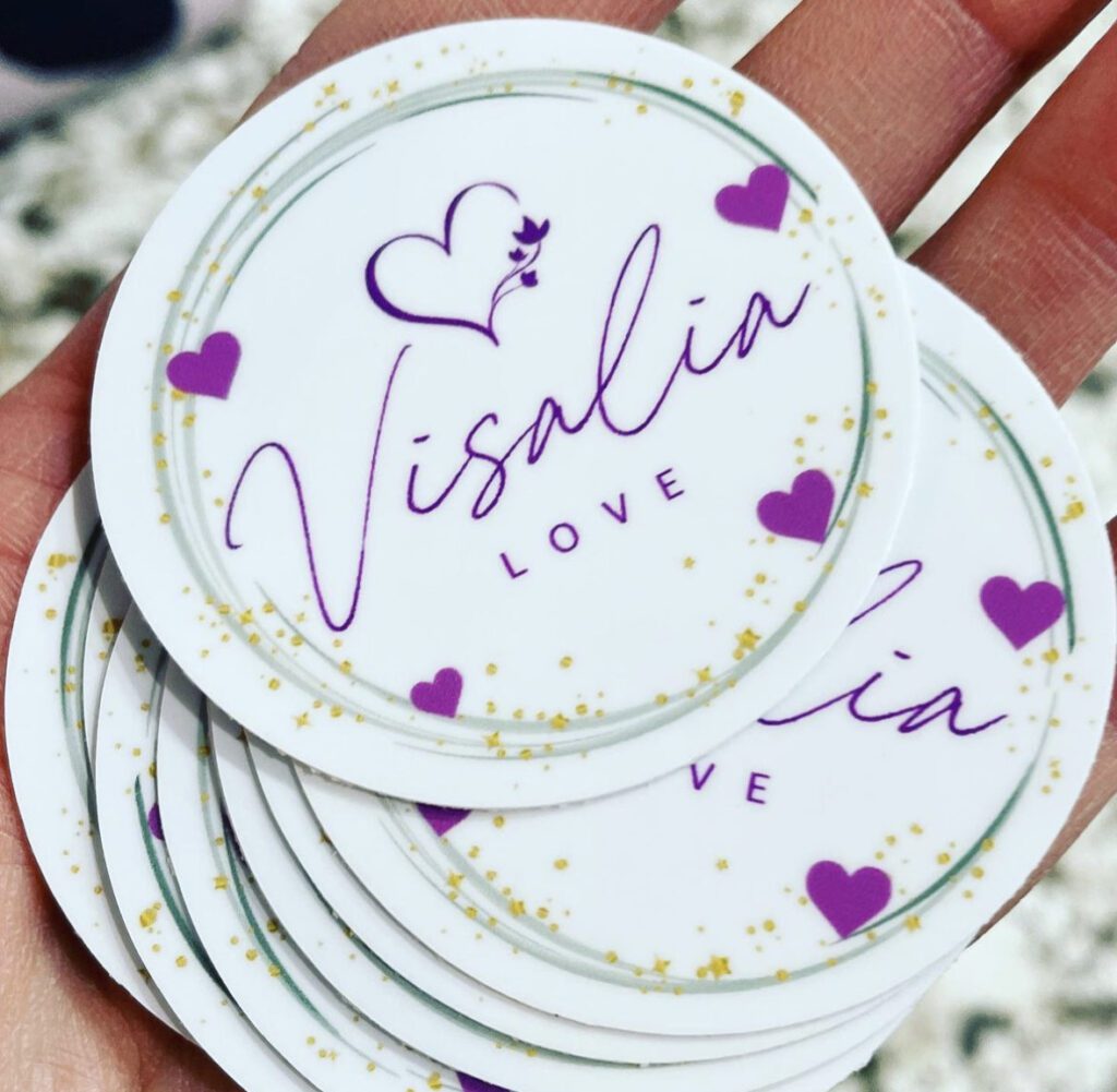 A stack of stickers with purple hearts and the name " visalin love ".